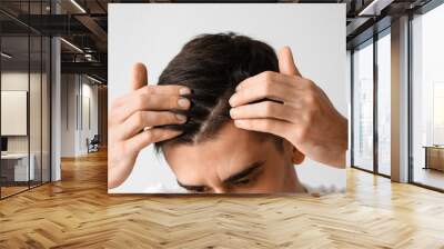 Handsome brunette man with hair loss problem on light background, closeup Wall mural