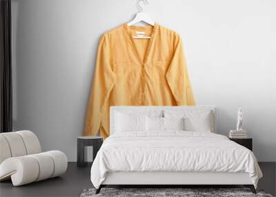 Hanger with stylish blouse on white background Wall mural