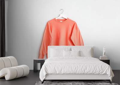 Hanger with stylish sweater on white background Wall mural