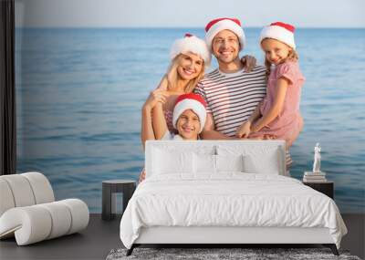 Happy family celebrating Christmas at tropical resort Wall mural