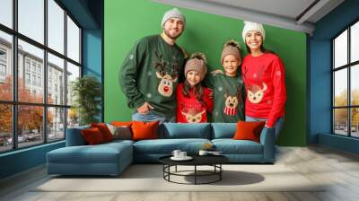 Happy family in Christmas sweaters on color background Wall mural