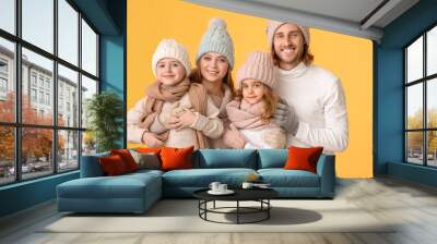 Happy family in winter clothes on color background Wall mural