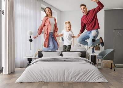 Happy family jumping at home Wall mural