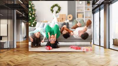 Happy family lying at home on Christmas eve Wall mural