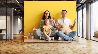 Happy family meditating during repair of their new house Wall mural