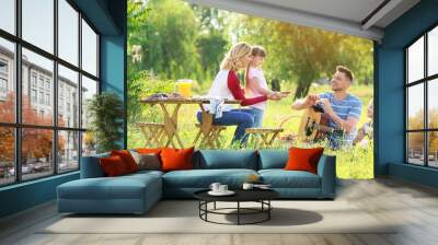 Happy family on summer picnic in park Wall mural