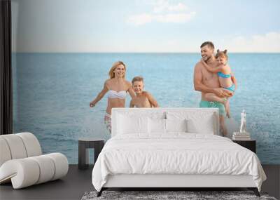 Happy family resting at sea resort Wall mural