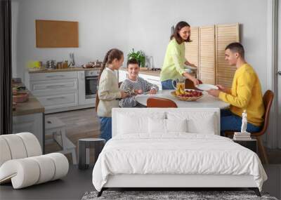 Happy family setting dining table in kitchen Wall mural