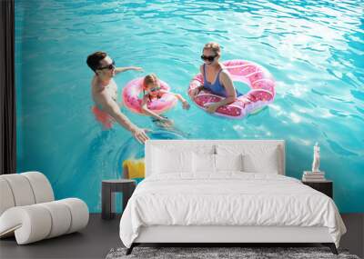 Happy family swimming in pool on summer day Wall mural