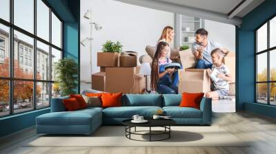 Happy family unpacking belongings in their new house Wall mural