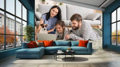 Happy family using laptop at home Wall mural