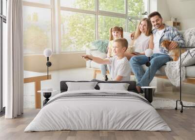 Happy family watching TV at home Wall mural