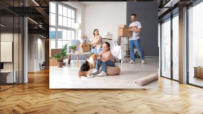 Happy family with Beagle dog packing things in room on moving day Wall mural