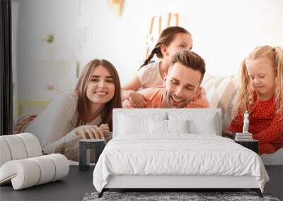 Happy family with cute cats on bed at home Wall mural