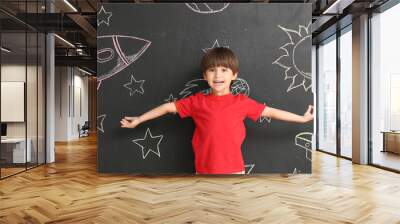 Happy little boy near blackboard with drawn space Wall mural