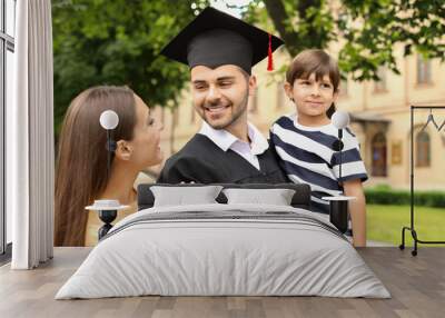 Happy man with his family on graduation day Wall mural