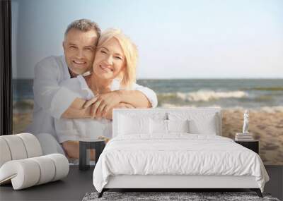 Happy mature couple at sea resort Wall mural