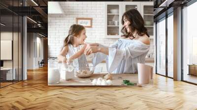 Happy mother with daughter preparing cookies in kitchen at home Wall mural