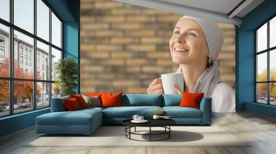 Happy woman after chemotherapy drinking tea at home Wall mural