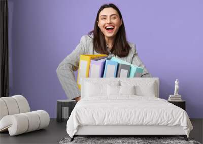 Happy young businesswoman with folders on lilac background Wall mural