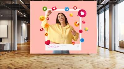 Happy young female blogger on pink background Wall mural