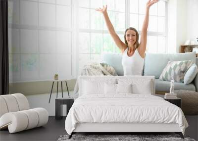 Happy young woman on scales at home. Weight loss concept Wall mural