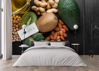 Healthy products rich in vitamin E on dark wooden background, closeup Wall mural