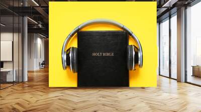 Holy Bible and modern headphones on color background Wall mural