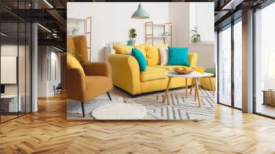 Interior of beautiful living room with yellow sofa, coffee table, armchair and shelving unit Wall mural