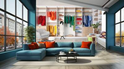 Interior of boutique with colorful clothes, mannequin and armchair Wall mural