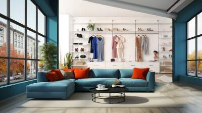 Interior of boutique with trendy clothes, shoes and accessories Wall mural