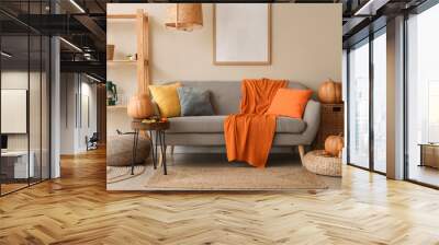 Interior of cozy living room with sofa, shelf unit and autumn decor Wall mural