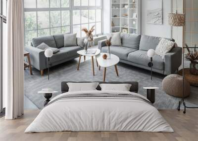 Interior of light living room with cozy grey sofas and coffee table near big window Wall mural