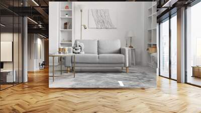 Interior of light living room with grey sofa, table and shelving units Wall mural