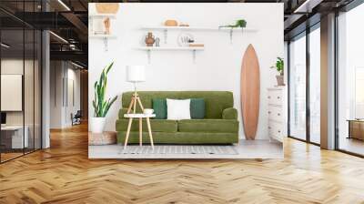 Interior of light living room with wooden surfboard, sofa and houseplants Wall mural