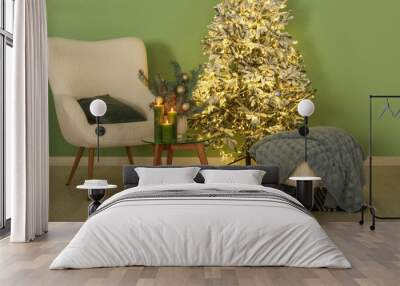 Interior of living room with armchair, pouf and glowing Christmas tree Wall mural