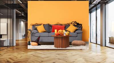 Interior of living room with sofa and Halloween pumpkins on table Wall mural