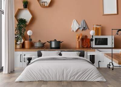 Interior of modern kitchen with white counters, electric stove and microwave oven Wall mural