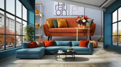 Interior of modern living room with autumn flowers in pumpkin and sofa Wall mural