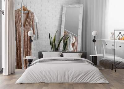 Interior of stylish dressing room with table, mirror and clothes Wall mural