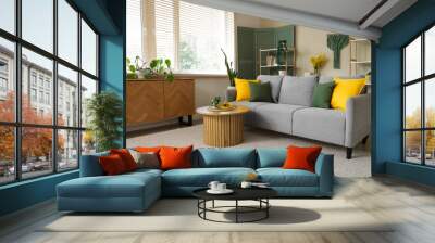 Interior of stylish living room with grey sofa, colorful cushions and coffee table Wall mural