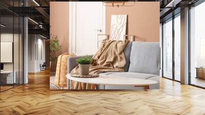 Interior of stylish living room with grey sofa and coffee table near beige wall Wall mural