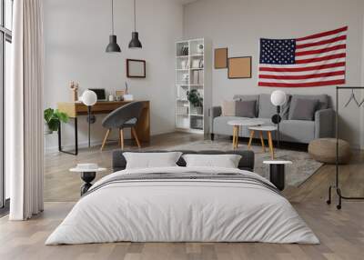 Interior of stylish office with modern workplace, laptop, cozy sofa and USA flag on white wall Wall mural