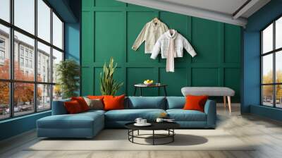 interior of stylish room with jackets hanging on color wall Wall mural