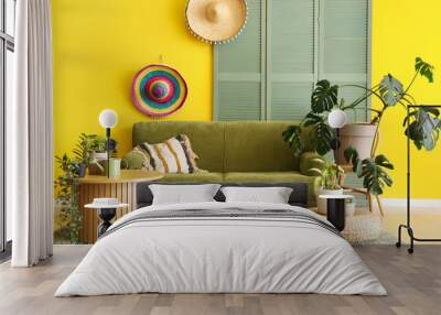 Interior of yellow living room with comfortable sofa, coffee table and houseplants Wall mural