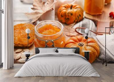 Jar of tasty pumpkin jam on table Wall mural