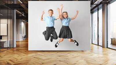 Jumping little pupils on light background Wall mural