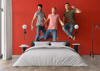 Jumping young men on color background Wall mural