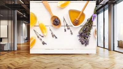 Lavender flowers with lemon pieces and honey on white wooden background Wall mural