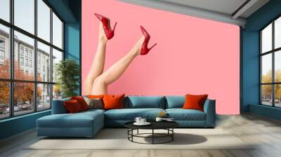 Legs of beautiful woman in high heels on color background Wall mural